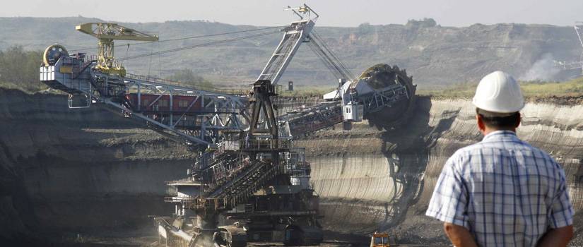 mining equipment in use as man looks on shows Lange Grinding and Machining custom machine parts for the mine industry in action