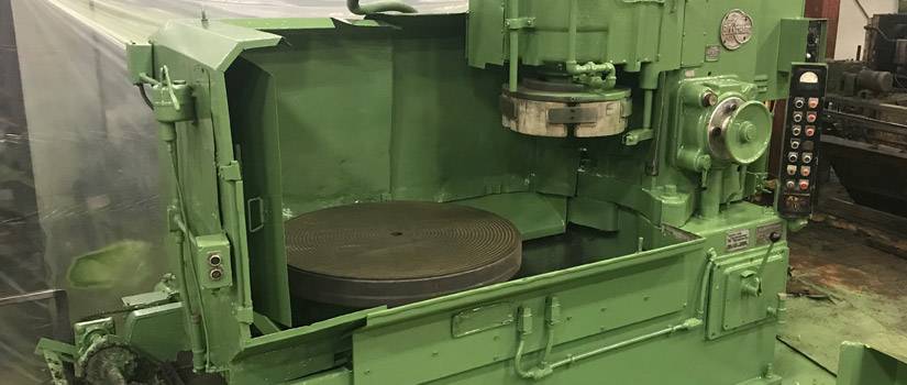 view of bright green blanchard grinder shows inner wheel located at Lange Grinding and Machining in Streetsboro, Ohio